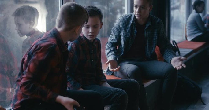 Boys bullying classmate in school corridor