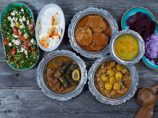 Eid Mubarak Traditional Ramadan Iftar dinner. Assorted tasty food in authentic rustic dishes on wooden table background.