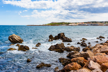 Fototapeta na wymiar View from the shore of the Paseo Maritimo of La Escala the port in the background. Costa Brava, Catalonia, Spain