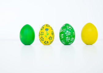 The concept of celebrating Easter. Colored and flower pattern painted eggs on white background. Copy space. Isolated. Close up