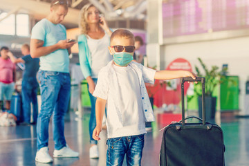 Coronavirus and Air pollution pm2.5 concept. Little boy wearing mask for protect pm2.5 in Airport terminal. coronavirus and epidemic virus symptoms.