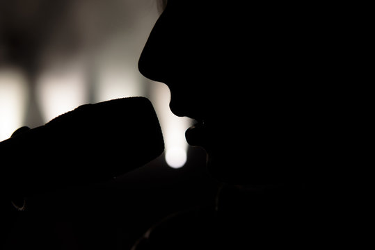 Singer in silhouette. Close up image of live singer on stage