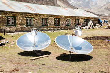 Warming the teapot in a solar cooker. Ecology concept. Renewable green energy. Nepal. Himalaya.