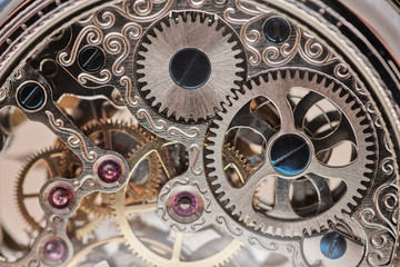 precise gears of a pocket watch, six rubies are seen - Powered by Adobe