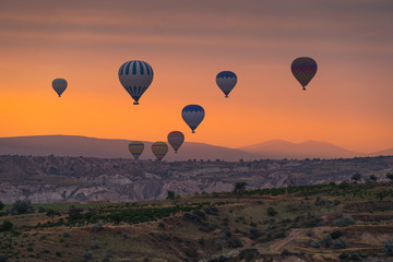 Hot air Bolloons over Cappadocia plaur in a morning sunrise, central Anatolia in Turkey