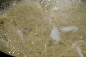 Some pasta boiling on a water