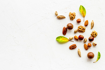 Nuts background - healthy snacks concept - on white table top-down frame copy space