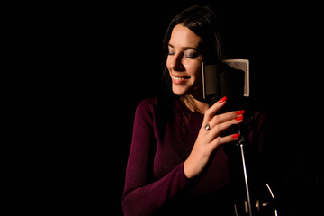 Professional musician recording new song in studio.