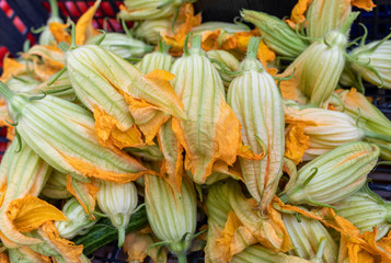 Fresh zucchini flowers at a farmers market in Italy