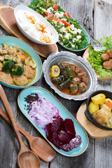 Eid Mubarak Traditional Ramadan Iftar dinner. Assorted tasty food in authentic rustic dishes on wooden table background.