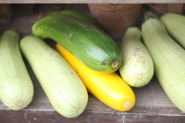 zucchini and peppers on wooden table