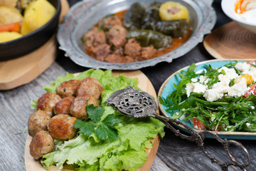 Eid Mubarak Traditional Ramadan Iftar dinner. Assorted tasty food in authentic rustic dishes on wooden table background.
