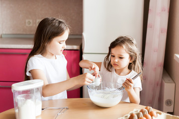 Sisters prepare Breakfast, pastries, mix flour, milk, eggs, pancakes in a bowl, children help mother, family Breakfast, cooking