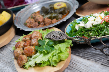 Eid Mubarak Traditional Ramadan Iftar dinner. Assorted tasty food in authentic rustic dishes on wooden table background.
