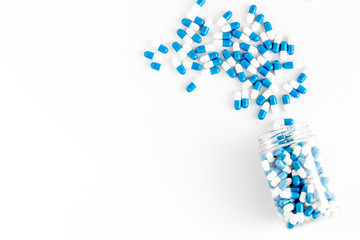 Creatine capsules. Pills scattered on white background top view