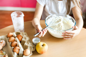 Girl prepare Breakfast, baking, stir in a bowl of flour, milk, eggs, pancakes, children help mother, family Breakfast, cooking