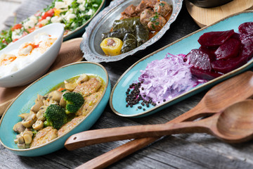 Eid Mubarak Traditional Ramadan Iftar dinner. Assorted tasty food in authentic rustic dishes on wooden table background.