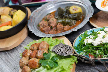 Eid Mubarak Traditional Ramadan Iftar dinner. Assorted tasty food in authentic rustic dishes on wooden table background.