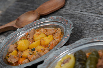 Eid Mubarak Traditional Ramadan Iftar dinner. Assorted tasty food in authentic rustic dishes on wooden table background.
