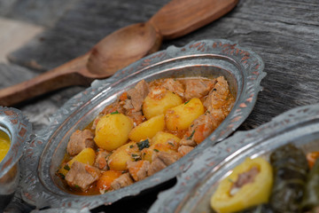 Eid Mubarak Traditional Ramadan Iftar dinner. Assorted tasty food in authentic rustic dishes on wooden table background.