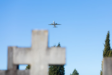 An airplane flies over the crosses in the Bilbao cemetery, Spain