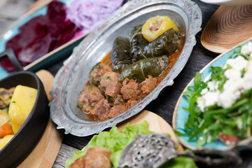 Eid Mubarak Traditional Ramadan Iftar dinner. Assorted tasty food in authentic rustic dishes on wooden table background.