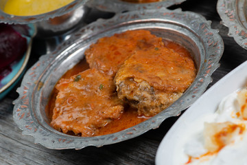 Eid Mubarak Traditional Ramadan Iftar dinner. Assorted tasty food in authentic rustic dishes on wooden table background.