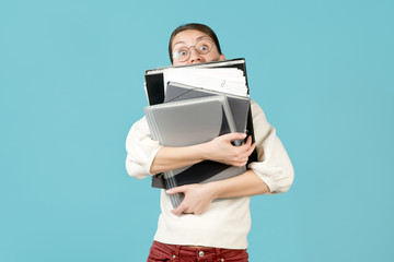 A young woman and a large number of work documents