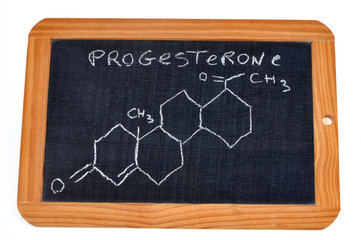 School slate on which is written the chemical formula of progesterone