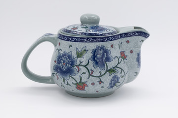 cup with tea and teapot on white  background, over light