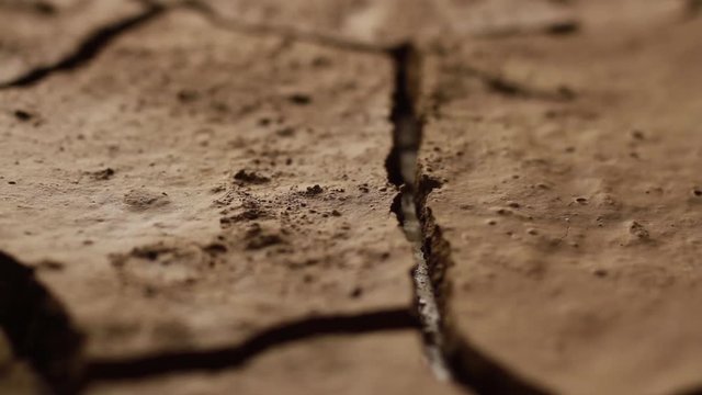 Dry mud cracked the impact of drought. River dried on summer effect to demand of water. water crisis cocept