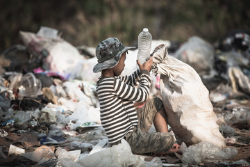 Poor boy collecting garbage in his sack to earn his livelihood, The concept of poor children and poverty