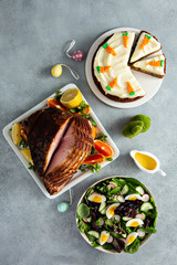 Big traditional Easter brunch with ham, spring mix salad and carrot cake