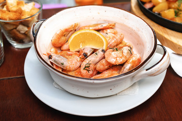 Grilled shrimp with lemon and spices on a white plate