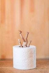 Toilet roll and man. The photo symbolizes loneliness and depression in conditions of self-isolation and quarantine. Problems of a modern consumer society.