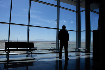 silhouettes of people in airport