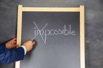 Impossible - possible. Text on chalkboard