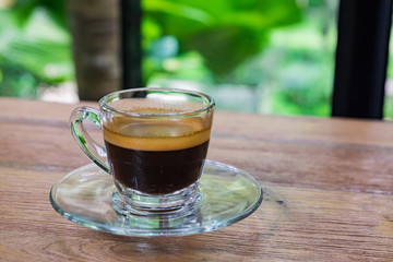 Cup of espresso coffee on wood background and Plumeria flowers fresh