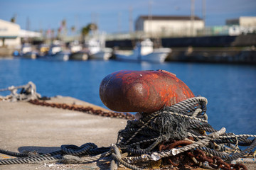 Rusty mooring post at the port
