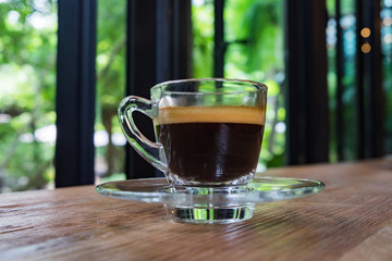 Cup of espresso coffee on wood background and Plumeria flowers fresh