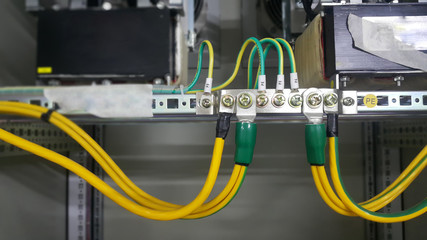 Ground wire connected to electrical equipment in industrial plants connect to ground copper bar in electric panel cabinet