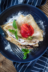 Polish pancakes with jam, cheese and strawberries.