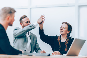 young employees giving each other a high five