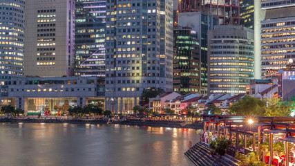 Obraz premium Singapore quay with tall skyscrapers in the central business district on Boat Quay day to night timelapse