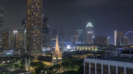Singapore skyline with St. Andrew's Cathedral aerial night timelapse hyperlapse.