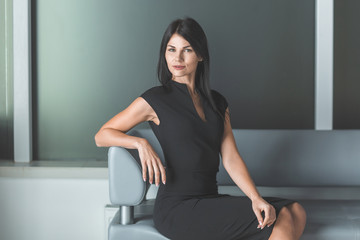 elegant business woman sitting in office lobby.