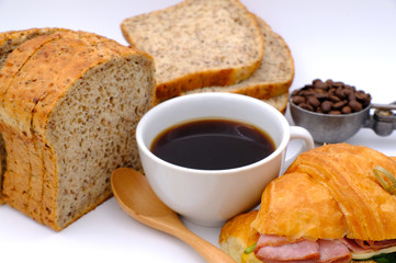Breakfast served with coffee, orange juice, croissants, fruits. Balanced diet.