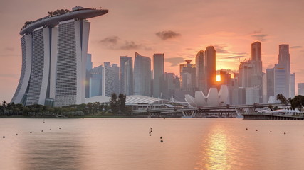 Sunset over the downtown skyline of Singapore as viewed from across the water from The Garden East...