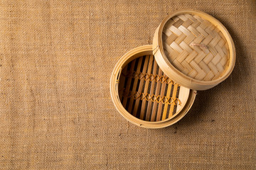Empty basket of dim sum made by bamboo material. Chinese Traditional cuisine concept. Dumplings Dim Sum in bamboo steamer with text copy space. Asian food background
