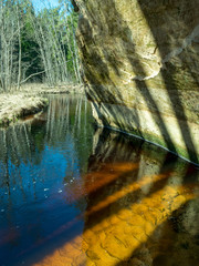 abstract picture with shadows and reflections on sandstone cliff wall